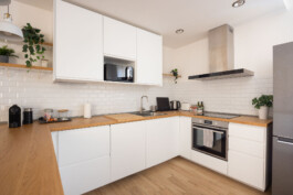 fotografo bologna bnb cucina luminosa con mobili bianchi e top in legno chiaro